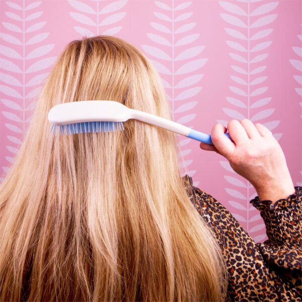 Elderly brushing hair brush